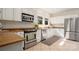 Well-lit kitchen with stainless steel appliances, granite countertops and stylish white cabinets at 316 S Summit Ave, Charlotte, NC 28208