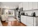 A modern kitchenette with white cabinets, granite countertops, and stainless steel appliances at 316 S Summit Ave, Charlotte, NC 28208