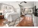 Bright main bedroom featuring hardwood floors, a ceiling fan, and many windows for natural light at 316 S Summit Ave, Charlotte, NC 28208