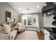 Sitting area featuring a large window, hardwood floors, and neutral decor at 316 S Summit Ave, Charlotte, NC 28208