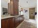 Well-lit bathroom featuring a double sink vanity with a tiled shower in a neutral palette at 3915 Ayscough Rd, Charlotte, NC 28211