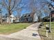 Charming two-story blue home with dormer windows and lush landscaping at 3915 Ayscough Rd, Charlotte, NC 28211