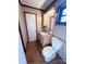 This cozy bathroom features a light wood vanity, medicine cabinet, and a white toilet at 4069 Amsbury Rd, Concord, NC 28025