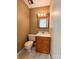Cozy bathroom with wood vanity, mirror with lights, and toilet with neutral design at 4069 Amsbury Rd, Concord, NC 28025