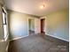 Comfortable bedroom featuring carpeted floors, a closet with mirrored doors, and a peaceful ambiance for rest at 4069 Amsbury Rd, Concord, NC 28025