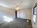Bright bedroom with plush carpet, closet, and ceiling fan for a comfortable, move-in-ready space at 4069 Amsbury Rd, Concord, NC 28025