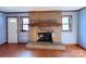 Classic brick fireplace with a wooden mantel for a cozy and inviting atmosphere at 4069 Amsbury Rd, Concord, NC 28025