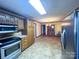 Spacious kitchen featuring stainless steel appliances, wooden cabinets, and an adjoining dining area, great for gatherings at 4069 Amsbury Rd, Concord, NC 28025