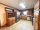 Well-appointed kitchen boasting wood cabinets, tile flooring, and stainless steel appliances, perfect for cooking at 4069 Amsbury Rd, Concord, NC 28025