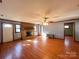 Spacious living room with a brick fireplace, hardwood floors, and natural light at 4069 Amsbury Rd, Concord, NC 28025