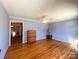 Bright living room featuring gleaming hardwood floors, ceiling fan, and a view into the adjacent space at 4069 Amsbury Rd, Concord, NC 28025