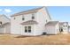 Exterior view of a home's backyard featuring a grassy area, patio, and adjacent houses at 418 Babbling Brook Ln # 245B, Locust, NC 28097