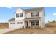 Charming two-story home with a two-car garage and a welcoming front porch at 418 Babbling Brook Ln # 245B, Locust, NC 28097