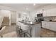 Modern kitchen with granite counters, stainless appliances, kitchen island with seating and easy access to the staircase at 418 Babbling Brook Ln # 245B, Locust, NC 28097