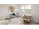 Bright office space with large window, stylish desk, comfortable seating, and modern decor at 418 Babbling Brook Ln # 245B, Locust, NC 28097