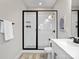 Modern bathroom featuring a glass-enclosed shower with a rainfall shower head and white tiled walls at 429 Grey Reagan Trl, Charlotte, NC 28211