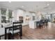 Open-concept kitchen and dining room featuring stainless steel appliances and wood floors at 429 Grey Reagan Trl, Charlotte, NC 28211