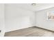 Bright, empty bedroom featuring wood-look floors, a window, and neutral walls at 4501 Knollcrest Dr, Charlotte, NC 28208