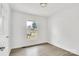 Bright, empty bedroom featuring wood-look floors, a window, and neutral walls at 4501 Knollcrest Dr, Charlotte, NC 28208