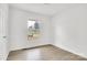 Cozy bedroom with a window offering outdoor views and wood-look flooring at 4501 Knollcrest Dr, Charlotte, NC 28208