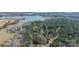 A scenic aerial view of a beautiful lakefront property nestled among lush green trees and pristine waters at 4552 Sawgrass Ct, Denver, NC 28037