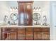Bathroom featuring double vanity with granite counters, decorative fixtures, and a large storage cabinet at 4552 Sawgrass Ct, Denver, NC 28037