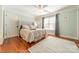 Bedroom featuring hardwood floors, ceiling fan, and natural light from a large window at 4552 Sawgrass Ct, Denver, NC 28037