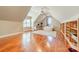 Spacious bonus room with hardwood floors, built-in shelving and sloped ceilings at 4552 Sawgrass Ct, Denver, NC 28037