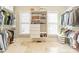 Well-organized walk-in closet with custom shelving and rods for ample storage and display at 4552 Sawgrass Ct, Denver, NC 28037