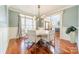 Bright dining room boasts hardwood floors, large windows and modern chandelier at 4552 Sawgrass Ct, Denver, NC 28037