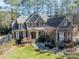 Beautiful two-story home featuring stone accents, red shutters and mature landscaping at 4552 Sawgrass Ct, Denver, NC 28037
