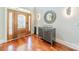 Welcoming foyer featuring hardwood floors, elegant mirror, and decorative lighting at 4552 Sawgrass Ct, Denver, NC 28037