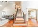 Inviting foyer with staircase, hardwood floors, and views into the living room and dining area at 4552 Sawgrass Ct, Denver, NC 28037