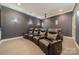A luxury home theater featuring leather seating, ambient lighting, and projector for immersive entertainment at 4552 Sawgrass Ct, Denver, NC 28037