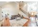 Spacious living room with hardwood floors, fireplace, and staircase at 4552 Sawgrass Ct, Denver, NC 28037