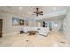 Spacious living room with tile floors and ceiling fan, featuring a comfortable white sectional and unique coffee table at 4552 Sawgrass Ct, Denver, NC 28037