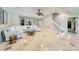 Large living room with tile floors and staircase, featuring a comfortable white sectional and a unique coffee table at 4552 Sawgrass Ct, Denver, NC 28037
