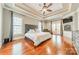 Spacious main bedroom with hardwood floors, trey ceiling, fireplace, and French door access to private balcony at 4552 Sawgrass Ct, Denver, NC 28037