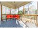 Cozy screened porch with bright orange cushioned seating area and views of the outdoors at 4552 Sawgrass Ct, Denver, NC 28037