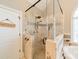 Tiled shower with a glass enclosure, bench, decorative tile accents, and a handheld shower fixture at 4552 Sawgrass Ct, Denver, NC 28037