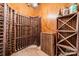 Climate-controlled wine cellar with custom wood racks for storing wine bottles at 4552 Sawgrass Ct, Denver, NC 28037