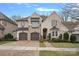 Beautiful two-story home with a brick driveway, attached garage, and manicured landscaping at 5128 Providence Retreat Ln, Charlotte, NC 28270