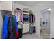 Functional walk-in closet with custom storage, and a laundry room with a washer and dryer in the background at 5128 Providence Retreat Ln, Charlotte, NC 28270