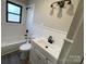 Cozy bathroom featuring white tile, a sink, and a window at 5135 Tucker Ave, Kannapolis, NC 28081
