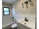Cozy bathroom featuring white tile, a sink, and a window at 5135 Tucker Ave, Kannapolis, NC 28081