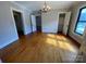 Bedroom featuring hardwood floors, a chandelier, and two windows for plenty of natural light at 5135 Tucker Ave, Kannapolis, NC 28081