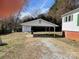 A single carport with a white roof and gravel driveway situated next to the home at 5135 Tucker Ave, Kannapolis, NC 28081