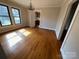 Dining area with hardwood floors, chandelier, and large windows for a bright interior at 5135 Tucker Ave, Kannapolis, NC 28081