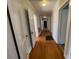 Long hallway featuring hardwood floors and multiple white doors at 5135 Tucker Ave, Kannapolis, NC 28081