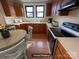 Cozy kitchen featuring wood cabinets, hardwood floors, and natural light from double windows at 5135 Tucker Ave, Kannapolis, NC 28081